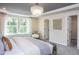 Main bedroom with large windows and carpet. Features a walk-in closet and ensuite bath at 769 Denburn Pl, Raleigh, NC 27603