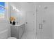 Modern bathroom features a glass shower and vanity with ample lighting at 8001 Wexford Waters Ln, Wake Forest, NC 27587