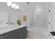 Stylish bathroom features gray cabinetry, modern fixtures, and a tiled shower and tub combination at 8001 Wexford Waters Ln, Wake Forest, NC 27587