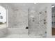 Luxury bathroom featuring marble walls, soaking tub and a glass-enclosed shower at 8001 Wexford Waters Ln, Wake Forest, NC 27587