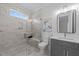 Beautiful bathroom boasts tiled shower with glass door, window, and modern fixtures at 8001 Wexford Waters Ln, Wake Forest, NC 27587