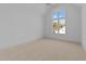 Bright bedroom with neutral carpet, large window, and ceiling fan at 8001 Wexford Waters Ln, Wake Forest, NC 27587