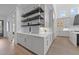 Chic butler's pantry featuring white cabinetry, floating shelves, stylish backsplash, and modern design at 8001 Wexford Waters Ln, Wake Forest, NC 27587