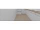 Walk-in closet with carpet flooring features built-in shelving for optimal storage at 8001 Wexford Waters Ln, Wake Forest, NC 27587