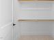 Walk-in closet featuring wooden rods for hanging clothes and carpet flooring at 8001 Wexford Waters Ln, Wake Forest, NC 27587