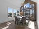 Bright dining room featuring large windows, wood accent wall, modern lighting and round table at 8001 Wexford Waters Ln, Wake Forest, NC 27587