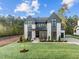 Two-story home with gray and white exterior, landscaping, and a large driveway at 8001 Wexford Waters Ln, Wake Forest, NC 27587