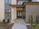 Welcoming front entrance featuring a stylish gray-tone exterior, glass paneled door, and landscaped walkway at 8001 Wexford Waters Ln, Wake Forest, NC 27587