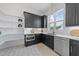 Well-designed kitchen featuring sleek black cabinets, stainless steel appliances, and stylish patterned flooring at 8001 Wexford Waters Ln, Wake Forest, NC 27587