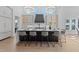Beautiful kitchen island with bar stool seating, modern light fixtures, and ample counter space at 8001 Wexford Waters Ln, Wake Forest, NC 27587