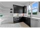 Modern kitchen with dark cabinets, patterned tile floor, and ample storage at 8001 Wexford Waters Ln, Wake Forest, NC 27587