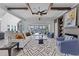 Spacious living room with beamed ceilings, fireplace, modern decor and large sliding glass doors at 8001 Wexford Waters Ln, Wake Forest, NC 27587