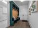 Mudroom area boasts wood accent wall with hooks and a bench, adjacent to the laundry room at 8001 Wexford Waters Ln, Wake Forest, NC 27587