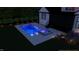 Night view of backyard pool with an integrated spa, lounge chairs, and outdoor lighting at 8001 Wexford Waters Ln, Wake Forest, NC 27587