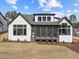 Rear exterior of home with screened porch and large windows for ample natural light at 8001 Wexford Waters Ln, Wake Forest, NC 27587