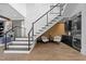 Modern staircase with metal railings leads to the upper level, with stylish bar area at 8001 Wexford Waters Ln, Wake Forest, NC 27587