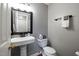 Clean and updated half bathroom with pedestal sink and toilet at 1006 Silent Retreat Ln, Knightdale, NC 27545