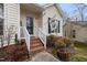 Front entrance with brick steps and a welcome flag at 1006 Silent Retreat Ln, Knightdale, NC 27545