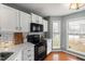 Modern kitchen with black appliances and white cabinets at 1006 Silent Retreat Ln, Knightdale, NC 27545