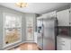 Bright kitchen features stainless steel refrigerator and ample natural light at 1006 Silent Retreat Ln, Knightdale, NC 27545