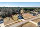 Aerial view of a two-story home on a large lot surrounded by a beautiful treeline and neighborhood at 105 Langdon Chase Way, Selma, NC 27576