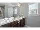 Bathroom with double sink vanity, large mirror, and natural light from a window at 105 Langdon Chase Way, Selma, NC 27576