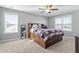 Spacious bedroom with natural light, ceiling fan, and a large bed frame with storage at 105 Langdon Chase Way, Selma, NC 27576