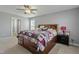 Spacious bedroom with natural light, ceiling fan, and a large bed frame with storage at 105 Langdon Chase Way, Selma, NC 27576