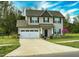 Attractive two-story home with two-car garage, well-kept lawn and blossoming tree at 105 Langdon Chase Way, Selma, NC 27576