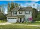 Charming two-story home with a two-car garage, landscaped yard and inviting front porch at 105 Langdon Chase Way, Selma, NC 27576