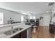 Open kitchen with granite countertops and a view into the adjacent living room at 105 Langdon Chase Way, Selma, NC 27576