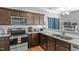 Modern kitchen with stainless steel appliances, granite countertops, and dark wood cabinetry at 105 Langdon Chase Way, Selma, NC 27576