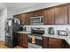 Well-equipped kitchen features stainless steel appliances, granite countertops, and subway tile backsplash at 105 Langdon Chase Way, Selma, NC 27576