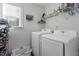 This laundry room features a front loading washer and dryer, shelving, and plenty of storage at 105 Langdon Chase Way, Selma, NC 27576