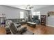 Inviting living room featuring a comfortable sofa, large windows, and stylish decor at 105 Langdon Chase Way, Selma, NC 27576