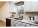 White cabinets, quartz countertops, and a window at 125 Havencrest Lndg, Garner, NC 27529