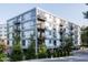 Modern apartment building with light colored metal panels and multiple balconies at 1300 St Marys St # 403, Raleigh, NC 27605