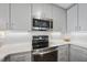 Modern kitchen with stainless steel appliances and white cabinetry at 1300 St Marys St # 403, Raleigh, NC 27605