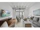 Living room features hardwood floors, large windows and comfy seating at 1300 St Marys St # 403, Raleigh, NC 27605