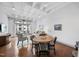 Bright living area with hardwood floors, dining table, and balcony access, perfect for relaxing at 1300 St Marys St # 403, Raleigh, NC 27605