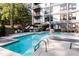 Community pool with lounge chairs and patio area at 1300 St Marys St # 403, Raleigh, NC 27605
