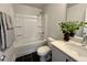 Bright bathroom featuring a tub and shower combo, sleek vanity and modern fixtures at 1364 Barreto Dr, Wendell, NC 27591
