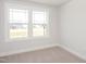 Bright bedroom featuring neutral carpet, a double window and light grey walls at 1364 Barreto Dr, Wendell, NC 27591