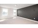 Bedroom features neutral carpet, grey accent wall, and double windows for bright light at 1364 Barreto Dr, Wendell, NC 27591