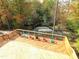 A wooden deck with colorful chairs provides an outdoor space surrounded by vibrant fall foliage at 1364 Barreto Dr, Wendell, NC 27591