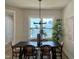 Bright dining room featuring a modern chandelier, natural light, and seating for six at 1364 Barreto Dr, Wendell, NC 27591