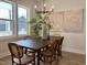 Bright dining room with modern chandelier, large windows, and seating for six, perfect for entertaining at 1364 Barreto Dr, Wendell, NC 27591