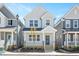Charming two-story home features a welcoming front porch with blue door, manicured landscaping, and craftsman-style design at 1364 Barreto Dr, Wendell, NC 27591