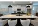 Modern kitchen with a large island, pendant lighting, stainless steel appliances, and bright white cabinetry at 1364 Barreto Dr, Wendell, NC 27591