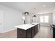 Bright kitchen with an island, stainless appliances, and a view of living room at 1364 Barreto Dr, Wendell, NC 27591